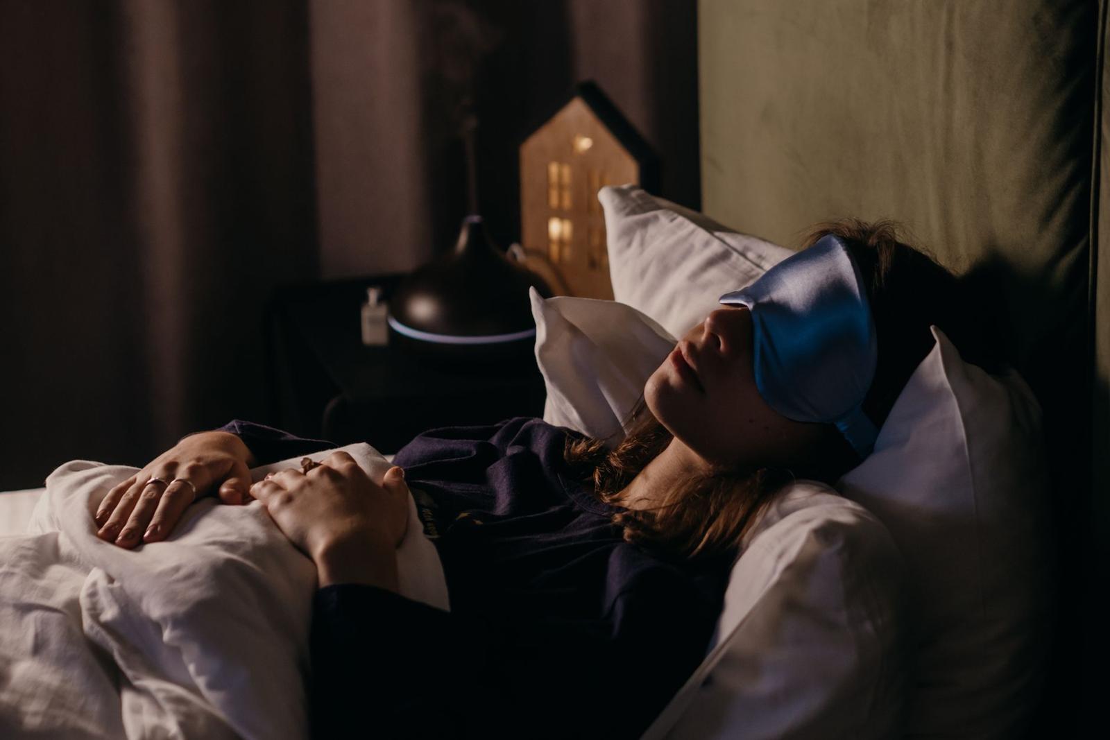 A Woman Sleeping Wearing a Sleep Mask