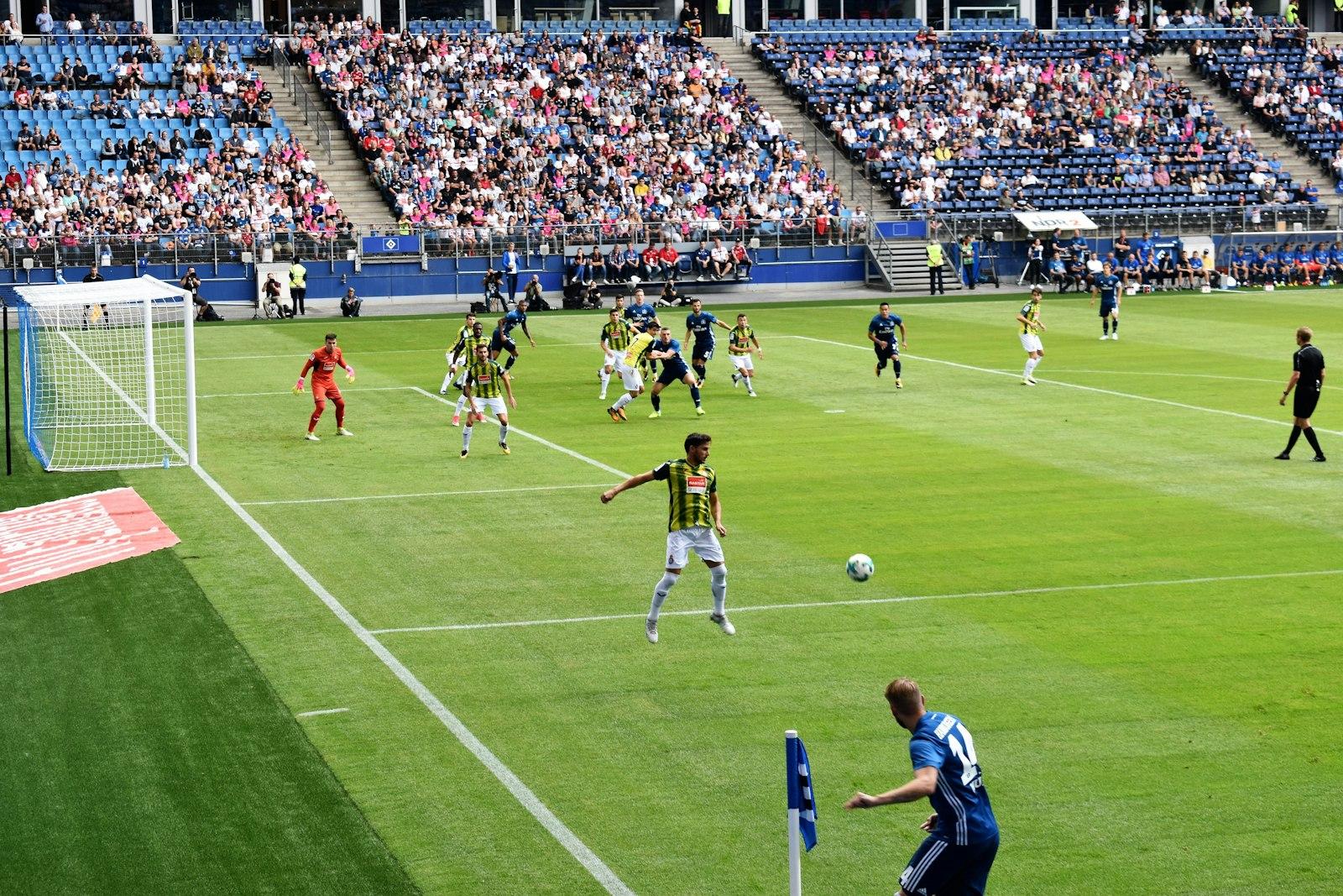 Men Playing Soccer of Soccer Field during Daytime